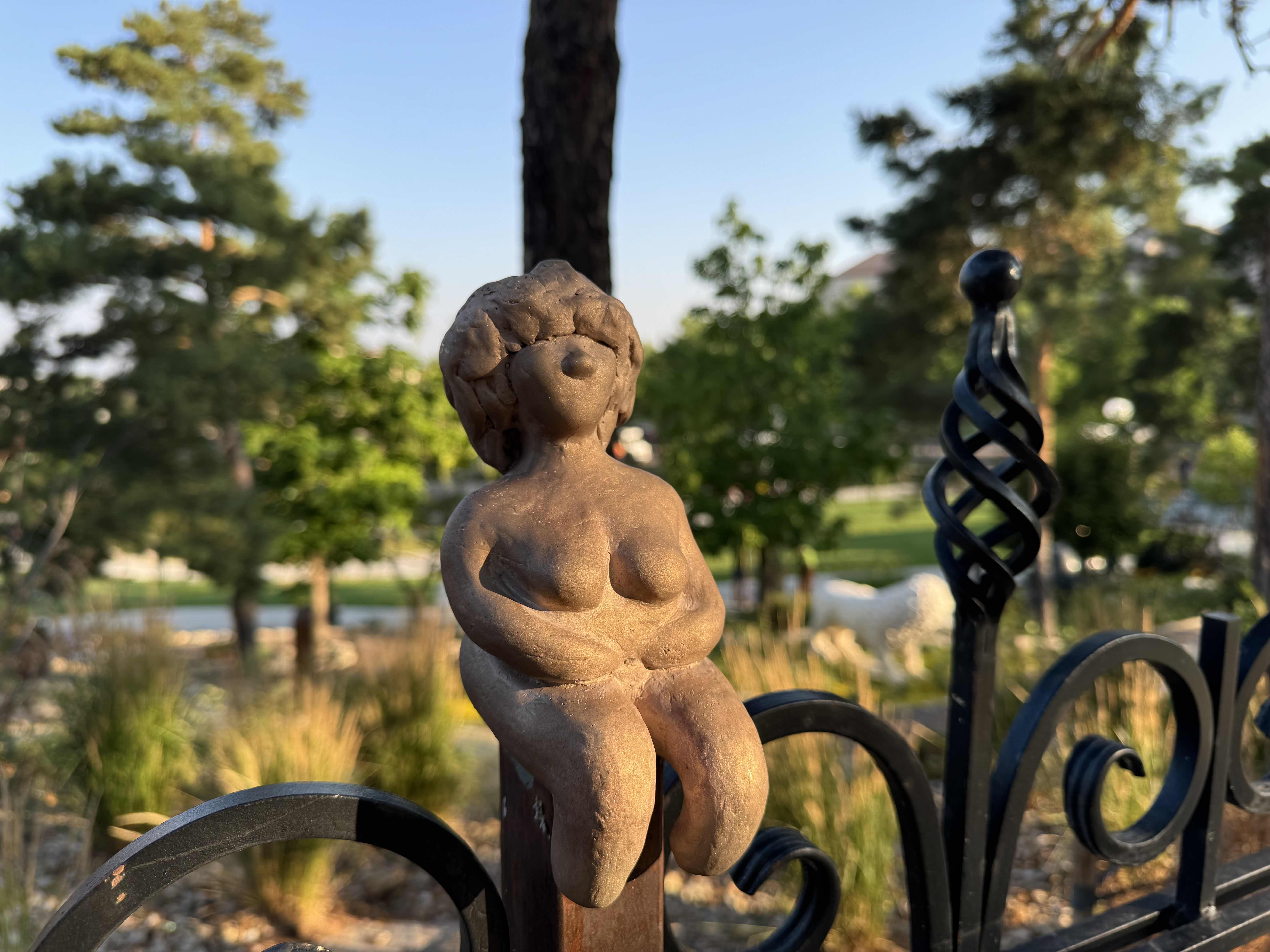 A sculpture on an iron fence